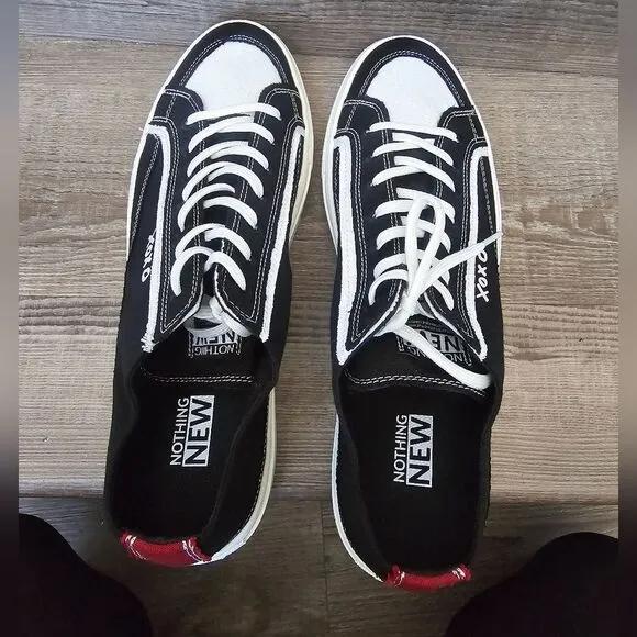 We are nothing new black and white casual tennis shoes Men's size 12.5